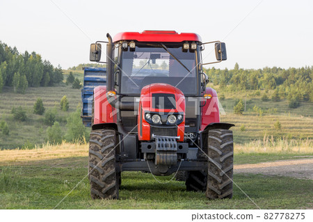 Red new wheeled tractor of medium size. 82778275