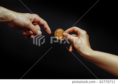 Bitcoin transfer concept from hand to hand. 82778711