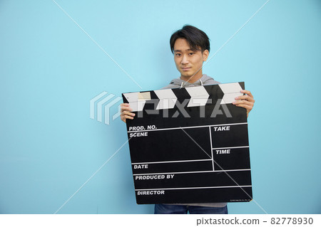 Japanese man with a big clapperboard 82778930