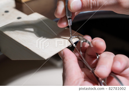 Optical technician fixing glasses. Close-up of male hands with screwdriver and goggles frame. Optical technician fixing glasses. Close-up of male hands with screwdriver and goggles frame. 82781002
