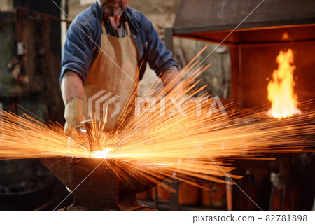 Blacksmith forging the iron 82781898