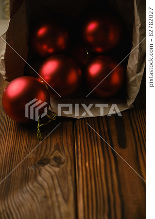 Red christmas balls in a box on a wooden table 82782027