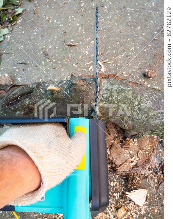 point-of-view shot of sawing limb with chain saw point-of-view shot of sawing limb with chain saw 82782129