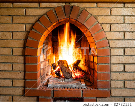 front view of brick fireplace with burning woods 82782131
