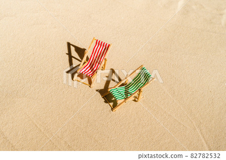Aerial view of two deck chair, sunbed, lounge on sandy beach. Summer and travel concept. Minimalism 82782532