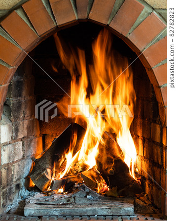 front view of fire in fireplace in country house front view of fire in fireplace in country house 82782823