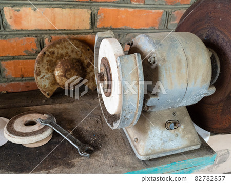 old electric grinding machine on workbench in barn old electric grinding machine on workbench in barn 82782857