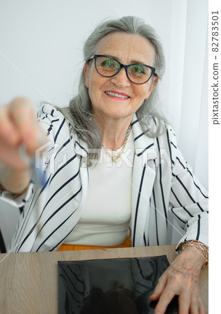 Senior realtor, estate agent makes real estate deal with home buyers, gives the keys frome new house with smile, mortgage loan, leasing service, sale purchase contract concepts 82783501