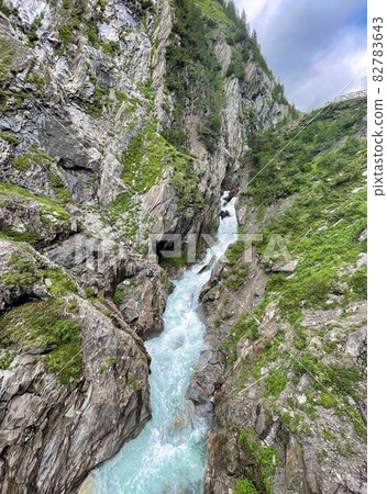 wanderpath in the rocks near a wild river wanderpath in the rocks near a wild river 82783643