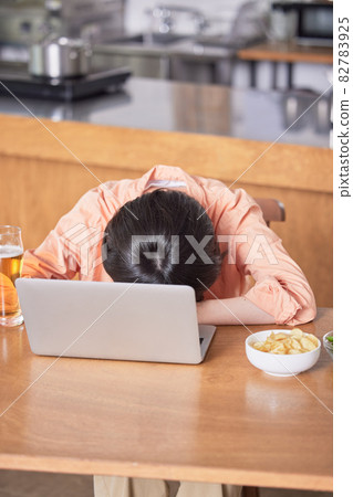 Young woman getting drunk at an online drinking party Young woman getting drunk at an online drinking party 82783925