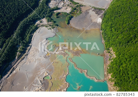 Drone view of the turquoise lake formed as a result of mining waste 82785343