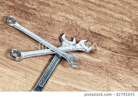 three wrenches iron one on top of the other on a wooden background three wrenches iron one on top of the other on a wooden background 82785835