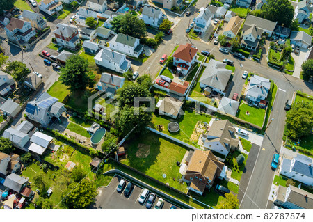 Aerial view of the residential area of beautiful suburb of home dwelling and road from a height. 82787874