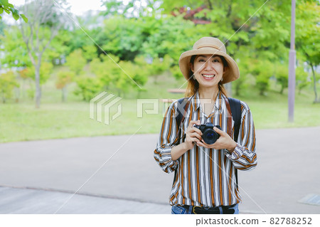 A woman with a camera A woman with a camera 82788252