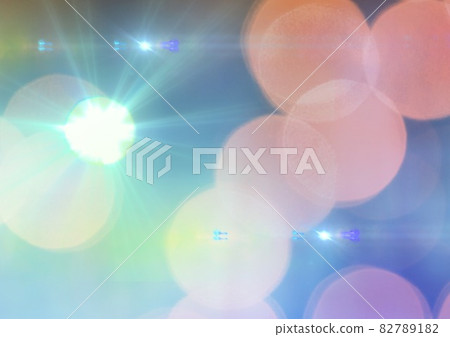 Glowing green spot of light over orange spots on blue background Glowing green spot of light over orange spots on blue background 82789182