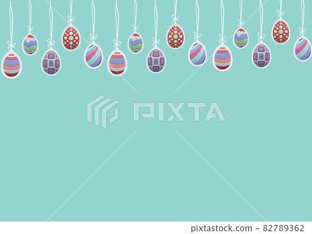 Multiple decorative colorful easter eggs hanging to string with copy space against green background 82789362