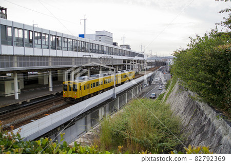 Fukuen Line train running with Fukuyama Station in the background 82792369