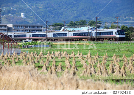 Odakyu Romancecar EXE-α running through rice fields after harvesting rice 82792428