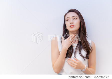 A woman holding a throat 82796376