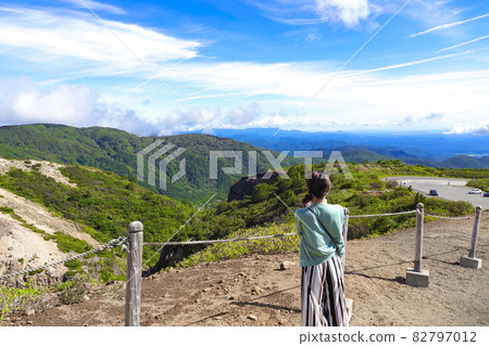 A woman sightseeing in Zao's Okama 82797012