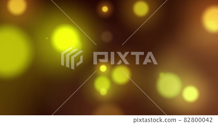 Image of yellow glowing spots of light moving in hypnotic motion on black background Image of yellow glowing spots of light moving in hypnotic motion on black background 82800042
