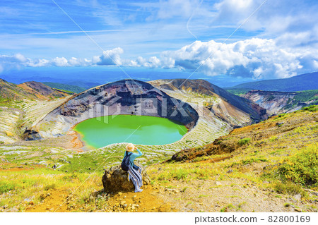 A woman sightseeing in Zao's Okama A woman sightseeing in Zao's Okama 82800169