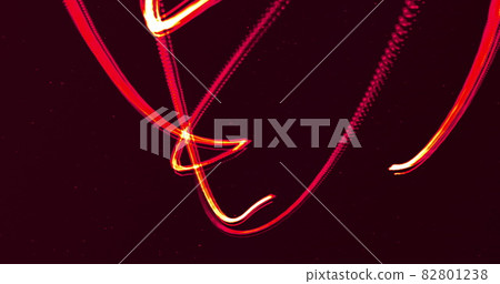 Two glowing red lines entertwining moving on a black background 82801238