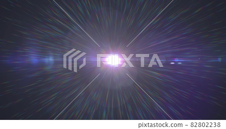 Glowing white spot of light glowing and rainbow rays moving against black background Glowing white spot of light glowing and rainbow rays moving against black background 82802238