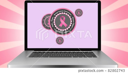 Composition of pink ribbon logo and breast cancer text on the laptop screen Composition of pink ribbon logo and breast cancer text on the laptop screen 82802743