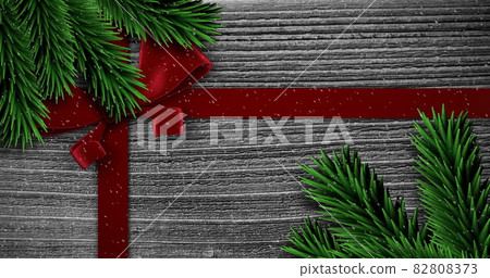 Image of christmas red present ribbon with snow falling on grey 82808373