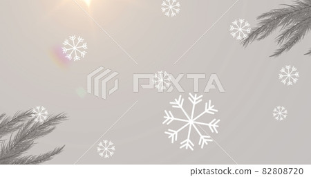 Digital image of snowflakes falling over ho ho ho text and bright spot of light Digital image of snowflakes falling over ho ho ho text and bright spot of light 82808720