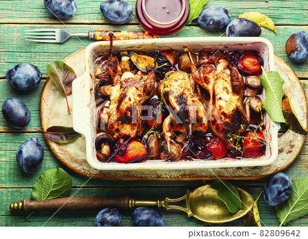 Tasty grilled quails with fall plums. 82809642