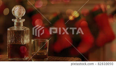 Image of wine decanter and glass, christmas stockings hanging Image of wine decanter and glass, christmas stockings hanging 82810050