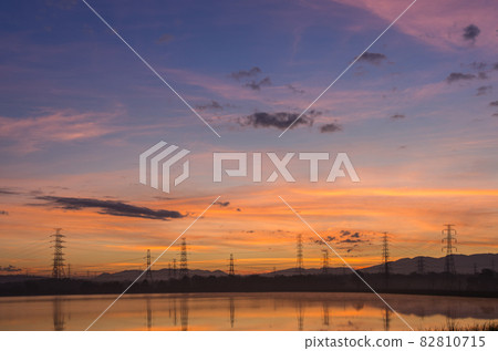 High voltage pole and lake. High voltage pole and lake. 82810715