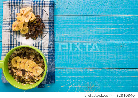 Porridge, oats, milk and banana on the table 82810840