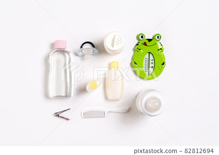 Hairbrush and cosmetics for newborns on a white background. Top view 82812694
