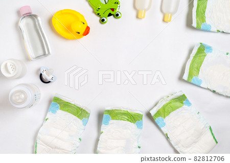 Babies goods diaper, baby powder, cream, shampoo, oil on white background with copy space. Top view or flat lay. 82812706
