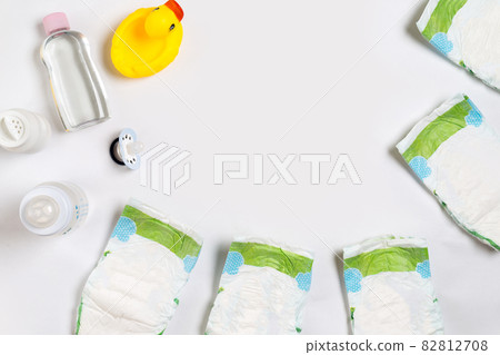 Babies goods diaper, baby powder, cream, shampoo, oil on white background with copy space. Top view or flat lay. 82812708