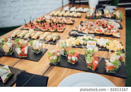 Buffet table of reception with cold snacks, meat and salads 82813167