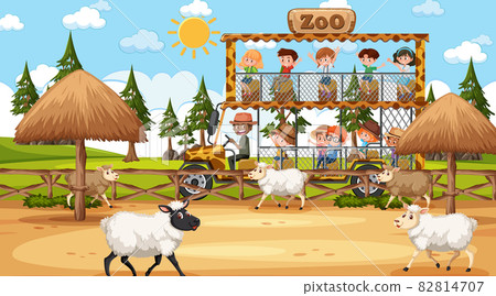 Safari at day time scene with many kids watching sheep group Safari at day time scene with many kids watching sheep group 82814707