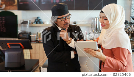 Customer satisfaction survey experience concept with muslim senior man and young woman standing and pressing smiling face emotion icon with five star excellent rating for service evaluation on tablet Customer satisfaction survey experience concept with muslim senior man and young woman standing and pressing smiling face emotion icon with five star excellent rating for service evaluation on tablet 82815406