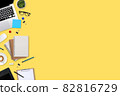 flat lay workspace table with laptop computer, office supplies, coffee cup, tablet and cell phone on yellow pastel background 82816729