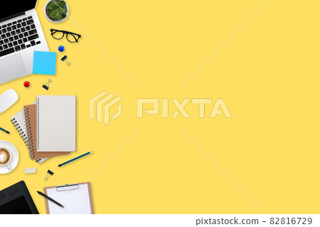 flat lay workspace table with laptop computer, office supplies, coffee cup, tablet and cell phone on yellow pastel background flat lay workspace table with laptop computer, office supplies, coffee cup, tablet and cell phone on yellow pastel background 82816729