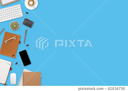 flat lay workspace table with laptop computer, office supplies, coffee cup, tablet and cell phone on blue pastel background flat lay workspace table with laptop computer, office supplies, coffee cup, tablet and cell phone on blue pastel background 82816730