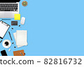 flat lay workspace table with laptop computer, office supplies, coffee cup, tablet and cell phone on blue pastel background 82816732