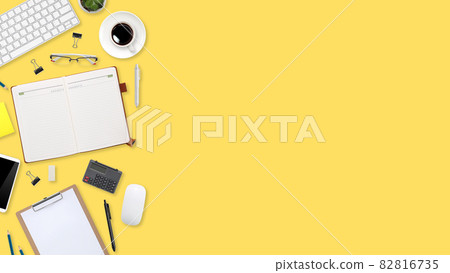 flat lay workspace table with laptop computer, office supplies, coffee cup, tablet and cell phone on yellow pastel background flat lay workspace table with laptop computer, office supplies, coffee cup, tablet and cell phone on yellow pastel background 82816735
