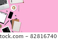 flat lay workspace table with laptop computer, office supplies, coffee cup, tablet and cell phone on pink pastel background 82816740