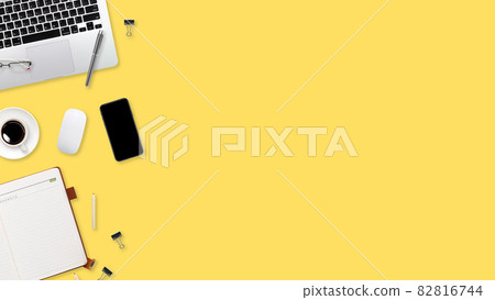 flat lay workspace table with laptop computer, office supplies, coffee cup, tablet and cell phone on yellow pastel background flat lay workspace table with laptop computer, office supplies, coffee cup, tablet and cell phone on yellow pastel background 82816744