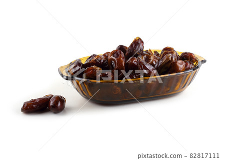 Date fruits on plate isolated on white Date fruits on plate isolated on white 82817111