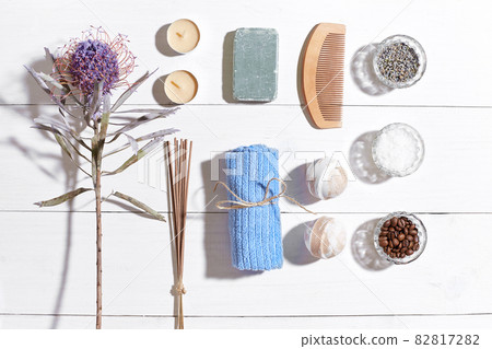 Spa set with sea salt, essential oil, soap and towel decorated with dry flower on white wooden background Spa set with sea salt, essential oil, soap and towel decorated with dry flower on white wooden background 82817282
